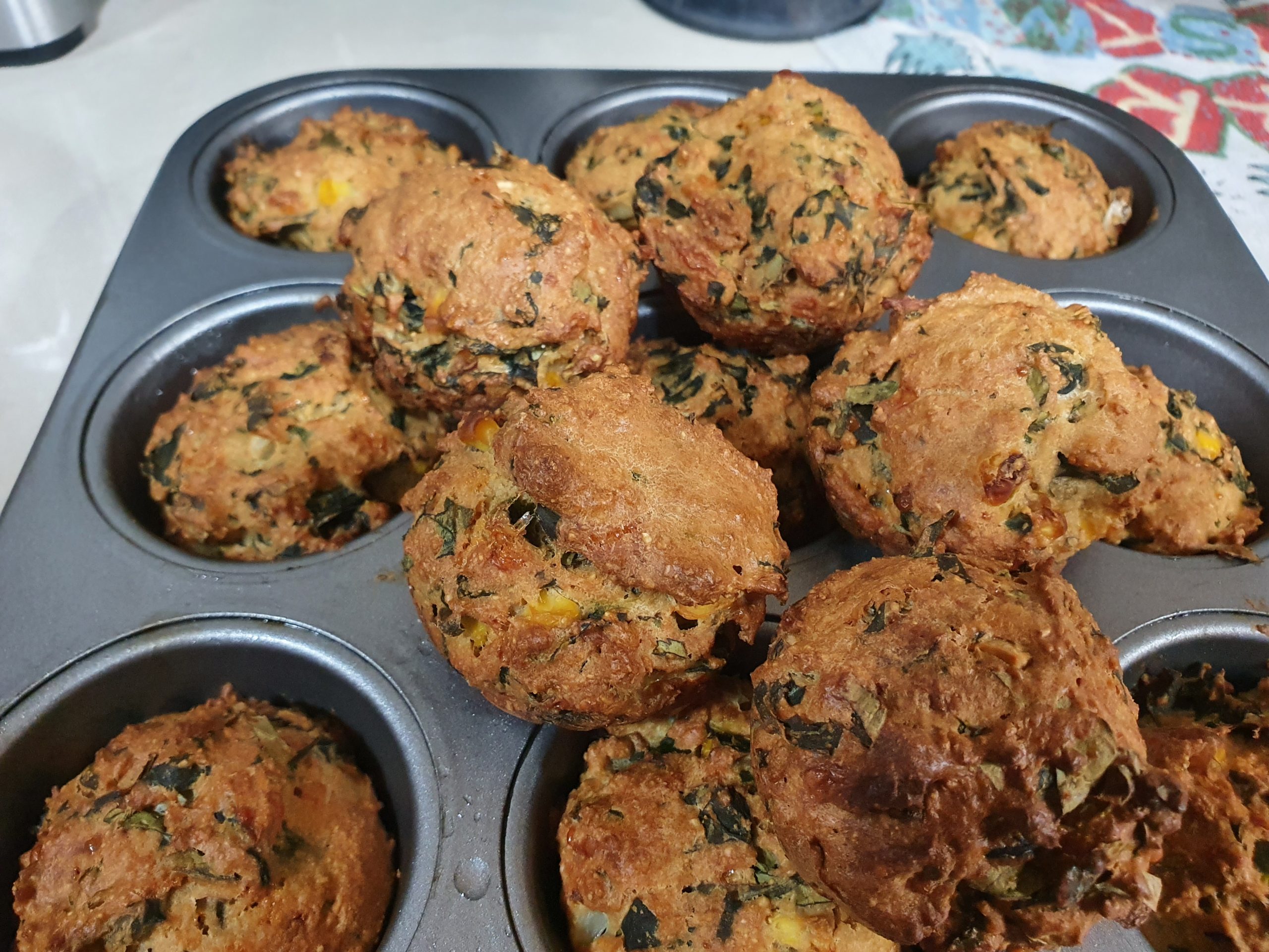 a tray of freshly baked, home made basil and spinach muffines